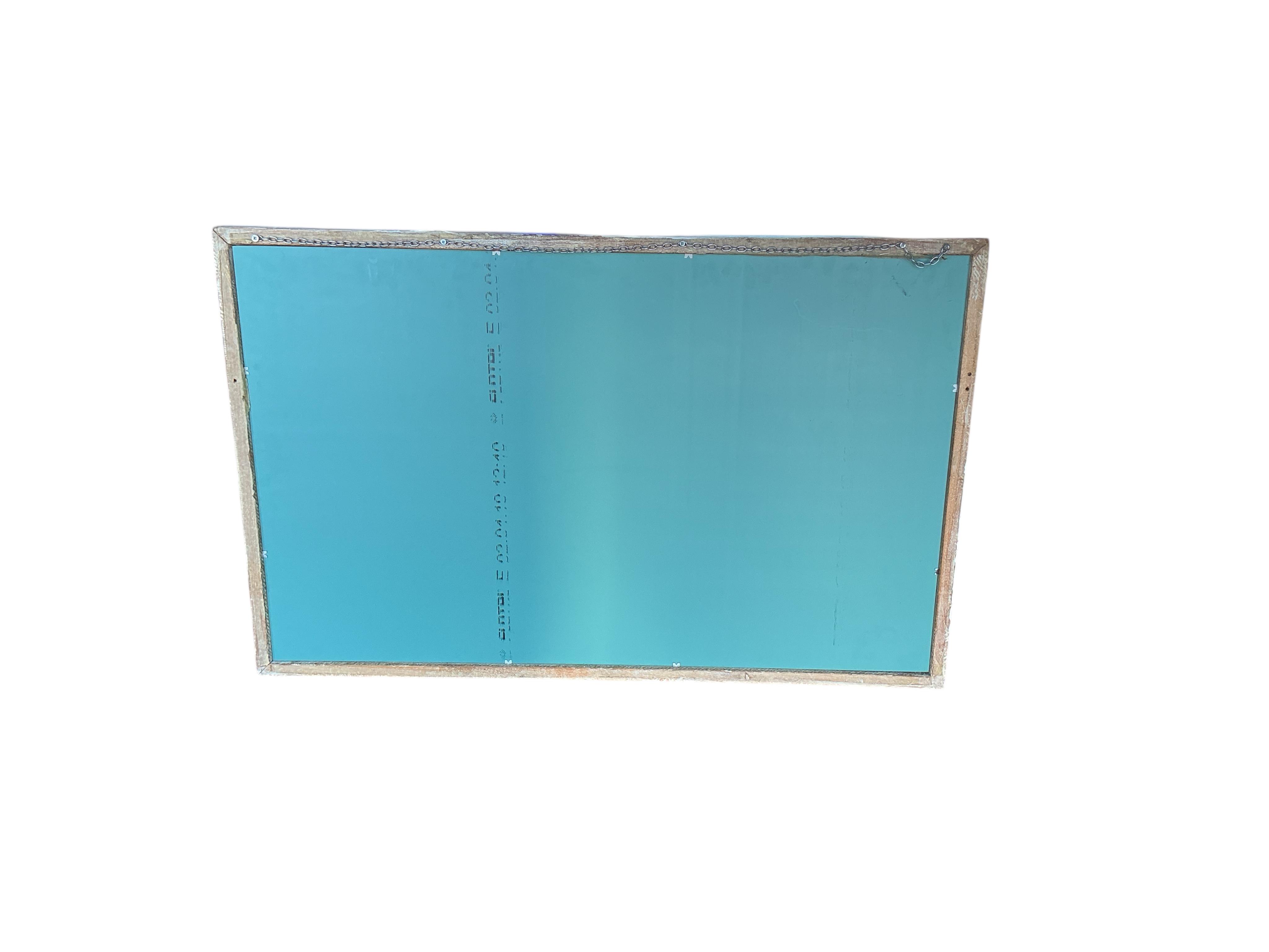 A Chinese carved hardwood wall mirror, later painted, width 93cm, height 60cm